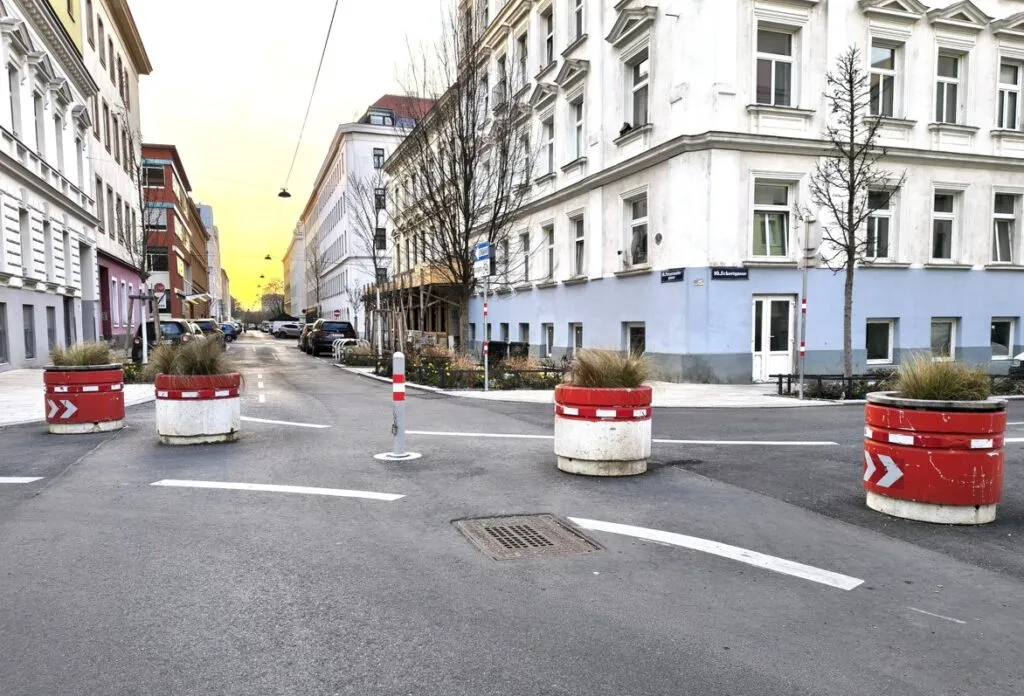 Bollards, concrete planter rings and young trees in Supergrätzl Favoriten.